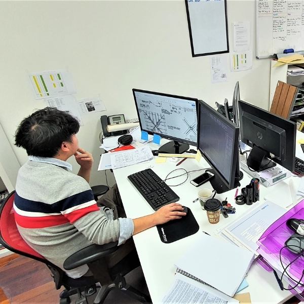 Tao at his desk with Structural engineering skills at ProConsult